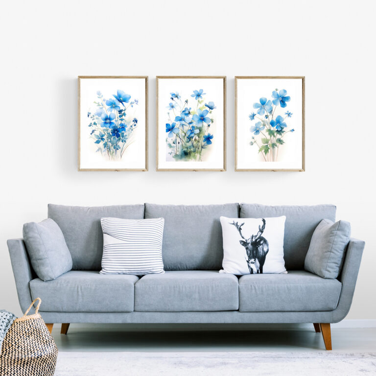 Cozy living room sofa in light blue with a 3-piece set of blue floral botanical wall art