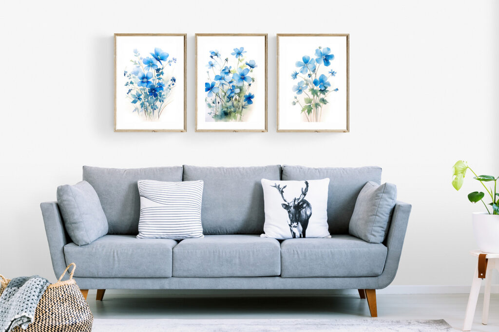 Cozy living room sofa in light blue with a 3-piece set of blue floral botanical wall art