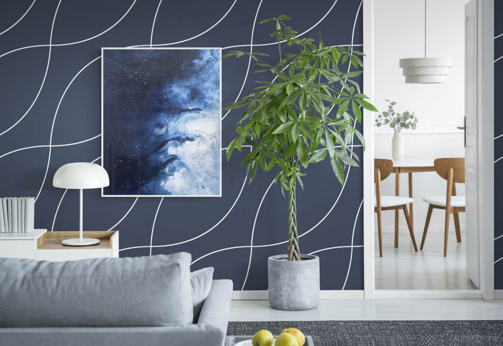 Frozen Starlight Icebergs - Night Sky and Icy Water Abstract Wall Art in a bright living room with navy blue wallpaper and large plant