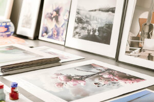 Fine art giclee prints laid out on a desk