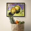 Vibrant lemon art print in black frame displayed above paper grocery bag filled with fresh fruits. Impressionist style citrus painting with bright purple and yellow background perfect for kitchen wall decor, dining room art, or colorful fruit themed home decor. Modern framed food artwork for farmhouse kitchen.