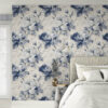 Classic blue peony toile wallpaper as bedroom accent wall with white upholstered bed, neutral linens and bright natural lighting