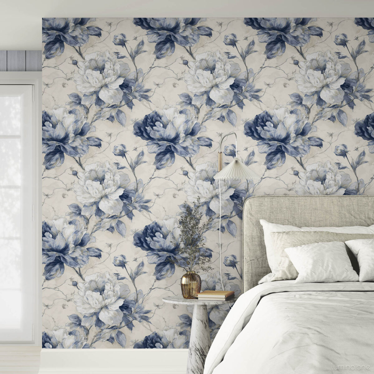 Classic blue peony toile wallpaper as bedroom accent wall with white upholstered bed, neutral linens and bright natural lighting