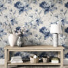 Classic blue peony toile wallpaper as dramatic living room statement wall with wooden console table, neutral decor and natural lighting