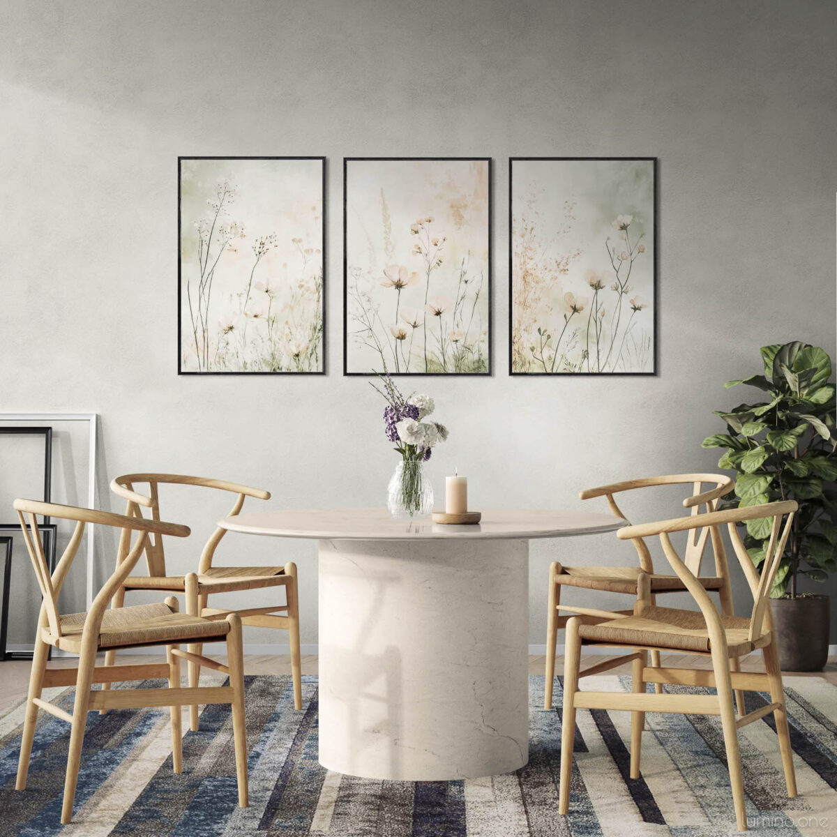 Set of three framed botanical prints featuring delicate wildflowers and dried grasses in neutral beige tones, displayed above a modern concrete dining table with wooden wishbone chairs in a contemporary dining room with gray walls