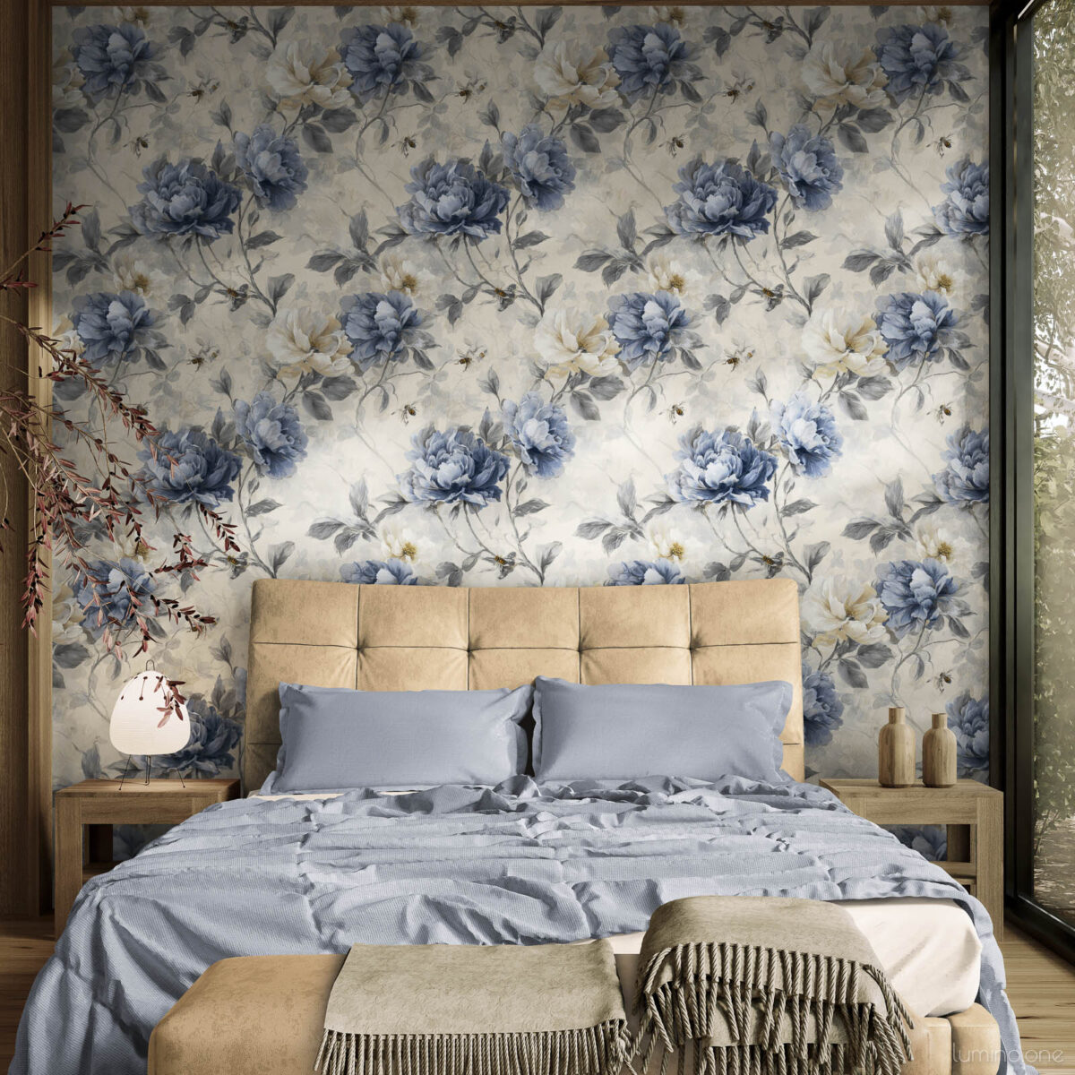 Vintage blue peony toile wallpaper as bedroom accent wall behind upholstered headboard with blue bedding and warm wood furniture