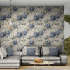 Vintage blue peony toile wallpaper displayed as accent wall in contemporary living room with gray sectional sofa and modern decor