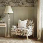 Floral Reading Chair with Exposed Beam Ceiling and Botanical Wallpaper in Rustic Cottage Bedroom