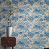 Blue Toile Peel and Stick Wallpaper - Vintage Botanical Garden P Blue and white toile peel and stick wallpaper on a full wall behind a mid-century modern walnut nightstand, featuring a vintage botanical garden pattern with large peony flowers and trees. Styled with a tall white textured vase holding dramatic white cherry blossom branches, showcasing the wallpaper's scale and detail in a bedroom setting.