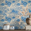 Blue Toile Peel and Stick Wallpaper - Vintage Botanical Garden P Blue and white toile peel and stick wallpaper on a full wall behind a taupe modern sideboard, featuring a vintage botanical garden pattern with large peony flowers and trees. Styled with a rustic stoneware vase holding cherry blossom branches, stacked vintage books, and crystal glass jars with brass lids.