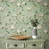 Chinoiserie Bird Wallpaper Peel and Stick - Sage Green Botanical Sage green chinoiserie vintage wallpaper with hand-painted birds, pink peonies, and lemon branches styled with matching sage green dresser with black cup pulls, wooden bowl, and striped ceramic vase with eucalyptus