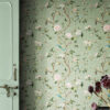 Chinoiserie Bird Wallpaper Peel and Stick - Sage Green Botanical Sage green chinoiserie peel and stick wallpaper with hand-painted birds, pink peonies, white blossoms, and lemon branches next to vintage mint green door with dried burgundy flowers
