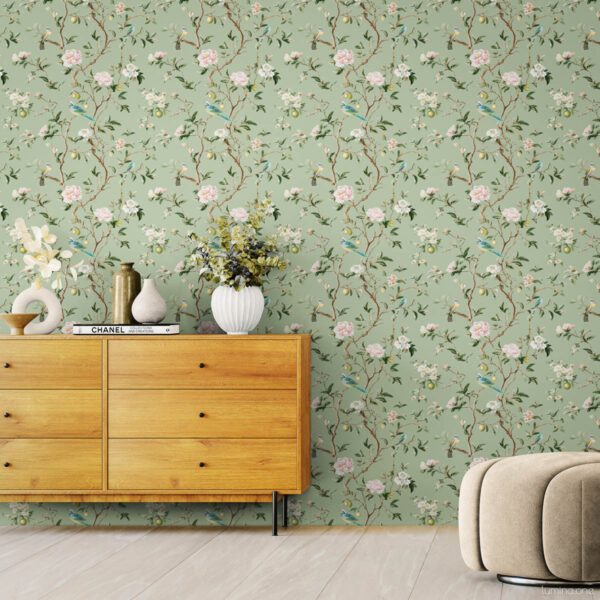 Chinoiserie Bird Wallpaper Peel and Stick - Sage Green Botanical Sage green chinoiserie peel and stick wallpaper with hand-painted birds, pink peonies, and lemon branches in modern living room with beige curved chair, wooden credenza, and white ceramic vases