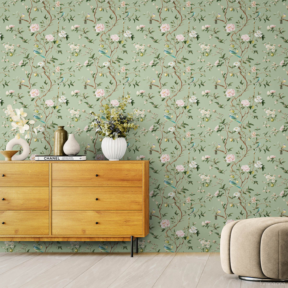 Chinoiserie Bird Wallpaper Peel and Stick - Sage Green Botanical Sage green chinoiserie peel and stick wallpaper with hand-painted birds, pink peonies, and lemon branches in modern living room with beige curved chair, wooden credenza, and white ceramic vases