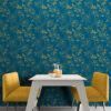 Bright dining nook with full wall dark teal and gold peony peel and stick wallpaper, paired with a white modern table and two mustard yellow accent chairs on concrete floors