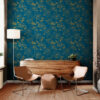 Modern sitting room accent wall with dark teal and gold peony peel and stick wallpaper, styled with two tan leather sling chairs, a walnut credenza, white floor lamp, and dried cherry blossom branches on wood floors